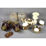 A pair of brass wall mounted oil lamps with ruby glass reservoirs later converted to electric