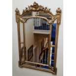 A 19th century giltwood mirror, the cresting with flowers and scrolling cartouche, within a marginal