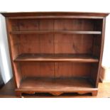 A 20th century mahogany bookcase with two height adjustable pegged shelves, raised on bracket