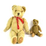Two vintage Teddy bears, one stuffed with wood wool.