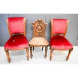 Two Victorian dining chairs with burgundy upholstery together with a Victorian oak hall chair with