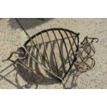 An antique wrought iron hay, collar and saddle rack