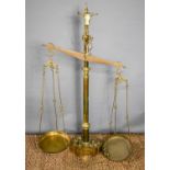 A large antique brass Portuguese balance / weighing scales, with a bulls head surmount, the base