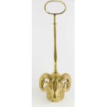 An antique brass door stop, in the form of a rams head, with hoop handle, 49cm high.