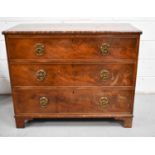 A George III mahogany chest of drawers, the rectangular top above three long drawers, with lion mask