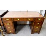 A 20th century campaign style pedestal desk, with brown leather inset writing surface, over an