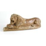 A Chinese carved soapstone Lion lying down, 35cm long.