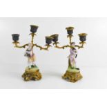 A pair of French porcelain candelabra, with three branches emanating from the porcelain figurines.