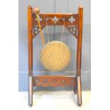 A Victorian Gothic style ceremonial dinner gong with fret pierced decoration and raised on trestle