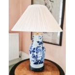 A 19th century blue and white Chinese vase converted to a lamp base, with carved hardwood stand.