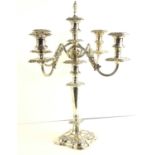 A silver plated five light candelabra, shaped square base rising to four reeded scroll arms, 51.