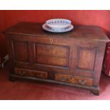 An early 18th century oak mule chest, the rectangular top with moulded edge, triple panel front,