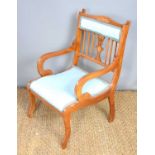 An Edwardian mahogany and inlaid bedroom chair covered in a blue woven material with closed back and