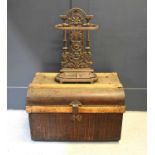 A Coalbrookdale style cast iron stick stand with removable tray together with a vintage tin trunk.