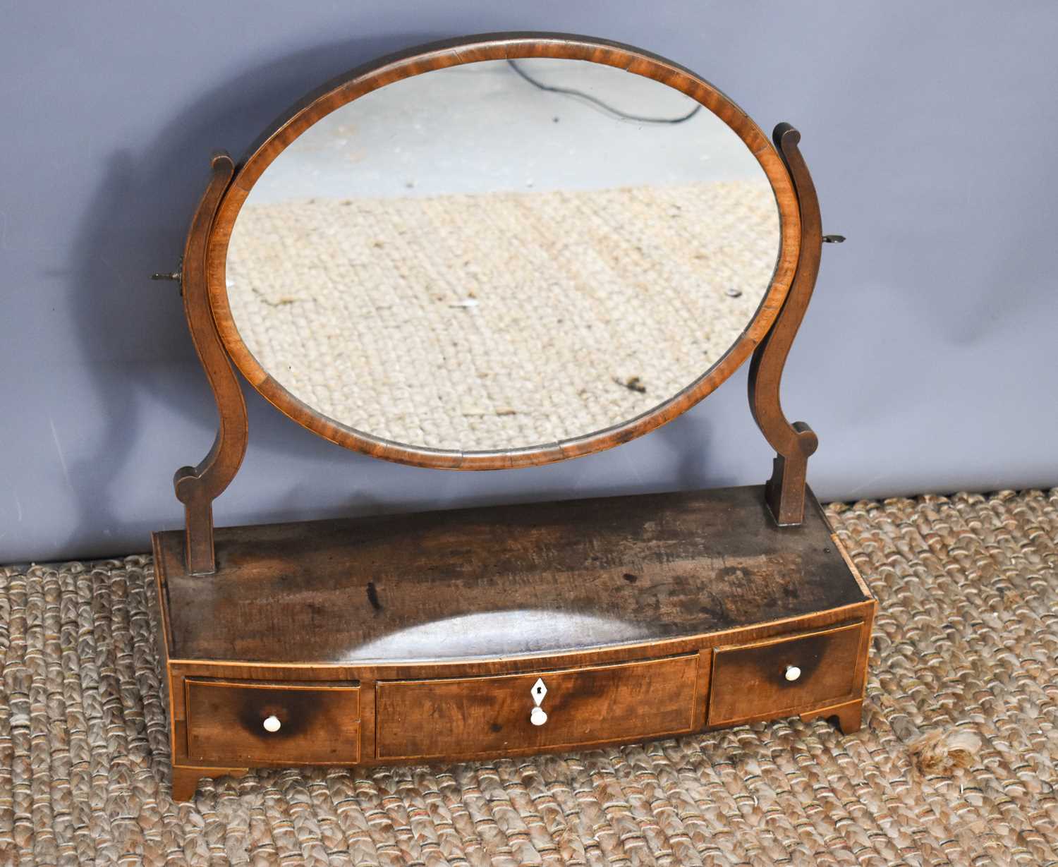 A 19th century mahogany toilet mirror with oval mirror and three drawers to the base, 58cm high by