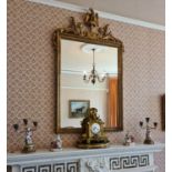 A 20th century gilded wall mirror, the cresting surmounted by an eagle, above a rectangular mirrored