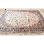A fine Kashmiri cream ground silk blend rug with foliate decoration throughout, 304cm by 213cm.