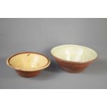 Two large terracotta bowls with glazed interiors, the largest measuring 36cm diameter.