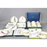 A Royal Worcester set of six coffee cans and saucers decorated with flowers in a fitted box together