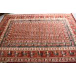 A John Lewis red ground wool rug, 300cm by 200cm.
