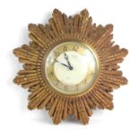A vintage Smiths 8-day starburst wall clock, 20.5cm by 20.5cm.