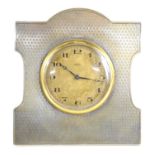 A 1920s silver eight day travel clock, easel back, hallmarked Birmingham, 10.5cm by 9.5cm.