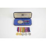 A British Civil Defence long service medal in the original case together with a set of WWII