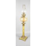 A Victorian marble effect oil lamp with glass chimney, 80cm high.
