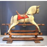 A 19th rocking horse, with rare raised saddle, 114cm high.