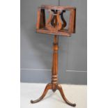 A 19th century rosewood music stand with twin height adjustable book rests above a lobed column