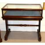 A 19th century rosewood table vitrine / display cabinet with turned under rail united by column form