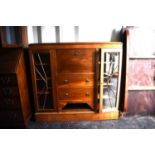 A 20th century mahogany cabinet, the pull down front above two drawers with two glazed doors