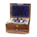 A Victorian ladies burr walnut vanity case containing eleven bottles and jars with white metal lids,