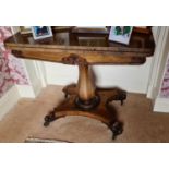 A 19th century rosewood card table, with baluster column, triform base, and raised on castors,