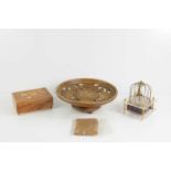 A vintage Sankyo musical bird in a cage together with a wooden musical dish, a musical box and a