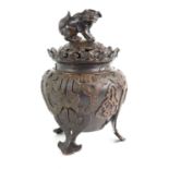 A Chinese bronze three footed censer with dog of Fo knop, 25.5cm high.