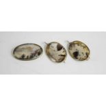 A silver and moss agate oval brooch and matching dress clips, with long posts to the back; secured