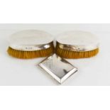 A pair of silver backed clothes brushes, and a silver cigarette case, Birmingam 1923, 2.91toz.