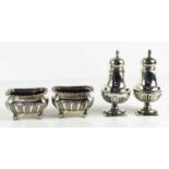 A pair of silver salts, raised on ball feet, together with a salt and pepper.