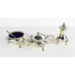 A silver condiment set, by Edward Barnard & Sons, comprising salt and salt spoon, mustard pot and