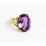 A 9ct gold and amethyst dress ring, the oval cut amethyst 1.7 by 1.3mm, size M, 7g.