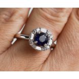 An 18ct white gold sapphire and mixed cut diamond ring, with IGLC certificate, size N, 6.1g.