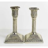 A pair of silver candlesticks, 19th century, with twisted columns, tulip candle sockets, and