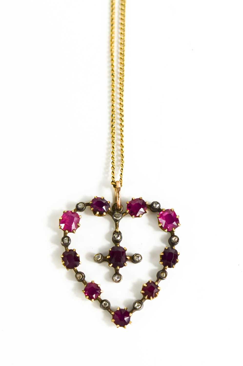 A 19th century 9ct gold, pink ruby and diamond heart form pendant and chain, the heart set with