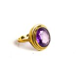 A 9ct gold and amethyst ring, oval cut with beaded gold mount, size L, 3.1g.