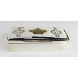 A large silver cigarette box, London 1896, with embossed armorial decoration in brass to the top and