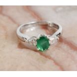 An 18ct white gold, oval emerald and pear shaped diamond ring, size M, 3.8g.