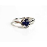 An 18ct white gold, sapphire and diamond ring, size L½, 3.8g.