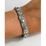 An exceptional Art Deco period platinum and diamond bracelet, each of the eleven primary links set