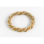 An 18ct gold and pearl bracelet, the string of pearls and gold in a ropetwist fashion, 23cm long,